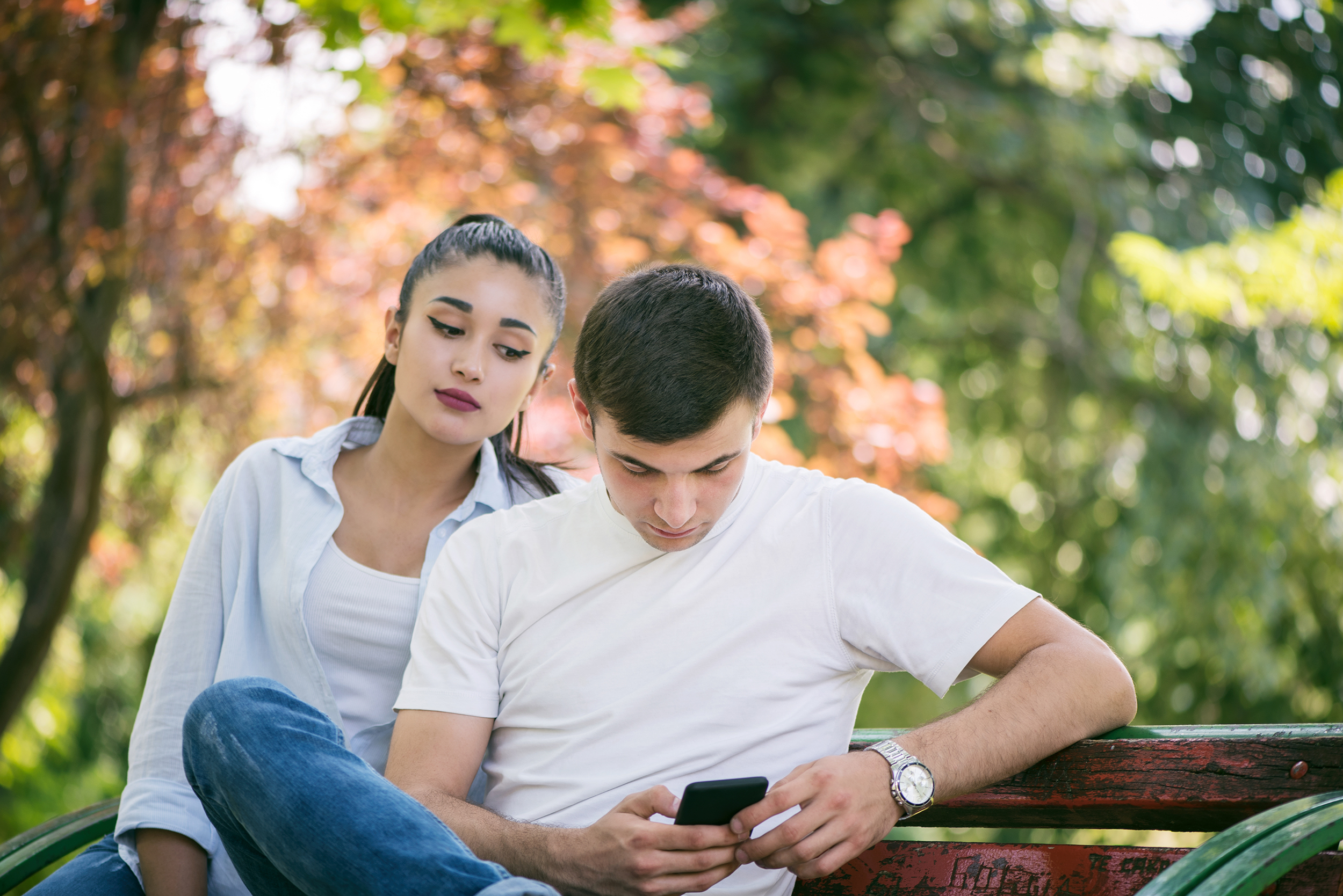 Girl and boy sitting on a bench cartoon